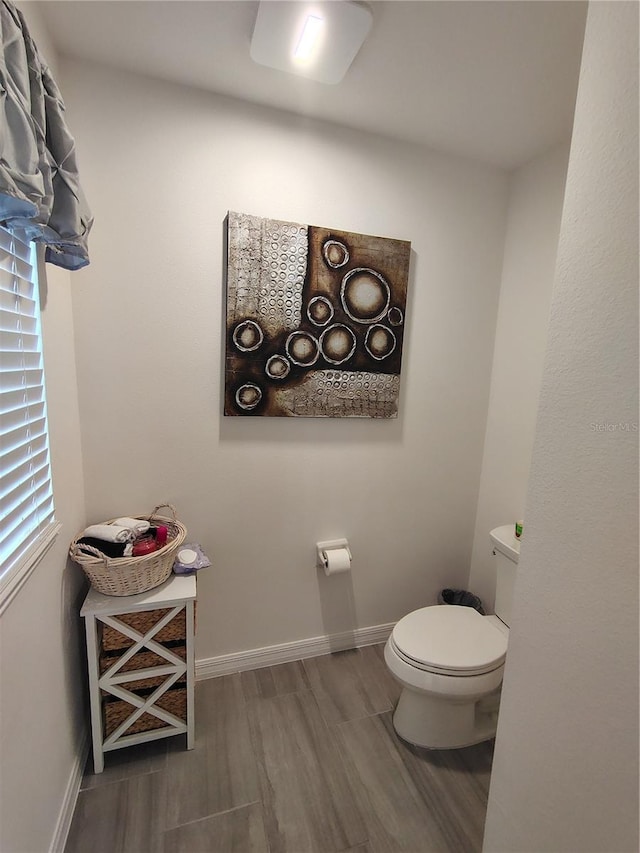 bathroom featuring hardwood / wood-style floors and toilet