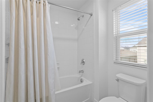 bathroom with toilet and shower / bath combo with shower curtain