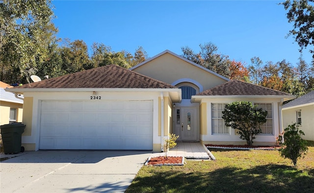 view of front of home featuring a garage and a front lawn