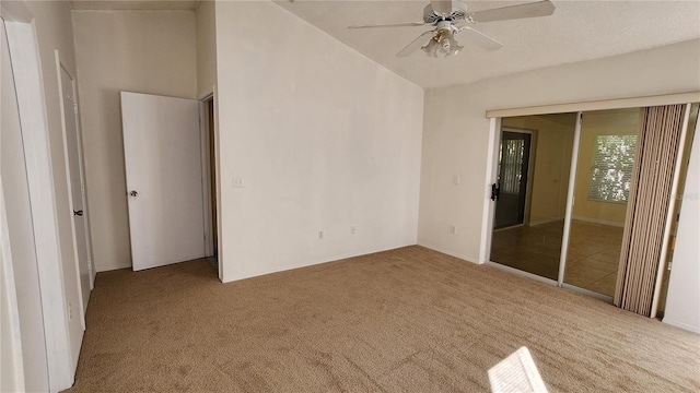 carpeted spare room with ceiling fan