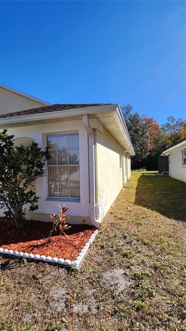 view of property exterior with a yard