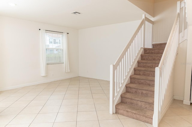 staircase with tile patterned floors