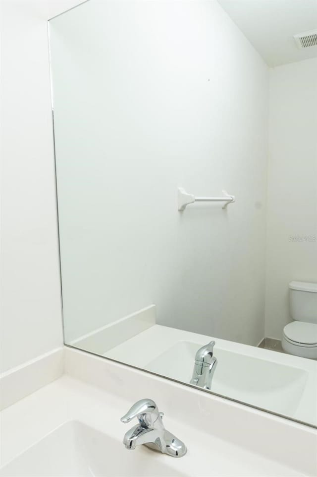 bathroom with toilet and vanity