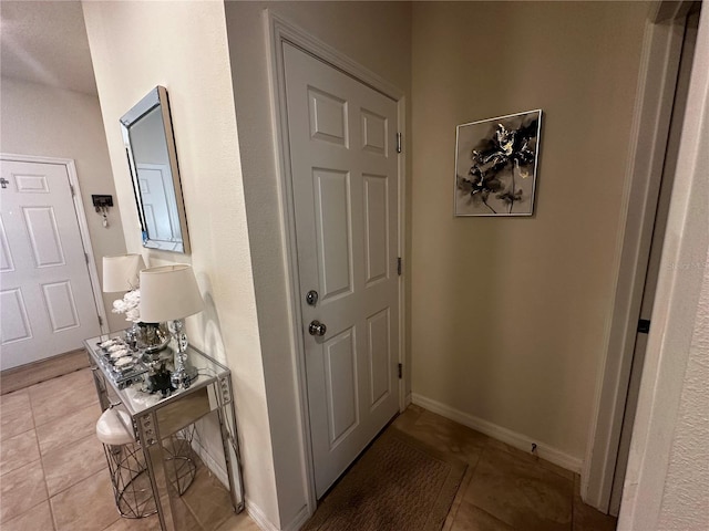 hall featuring light tile patterned flooring