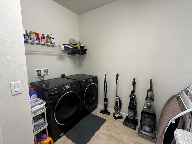 washroom with light tile patterned flooring and washer and dryer