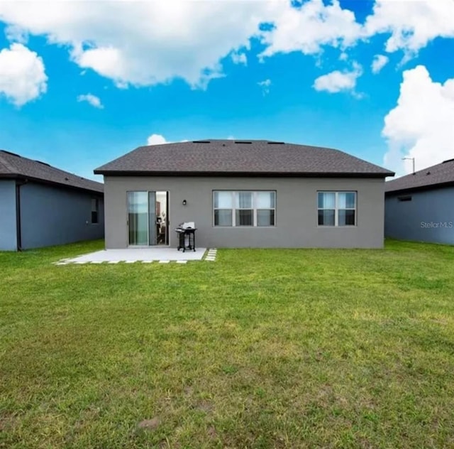 back of house featuring a yard and a patio