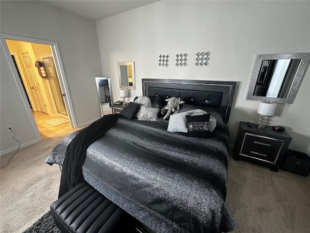 bedroom featuring ensuite bathroom and dark colored carpet