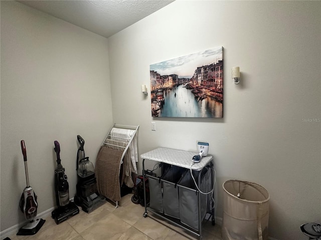 miscellaneous room featuring light tile patterned floors and a textured ceiling