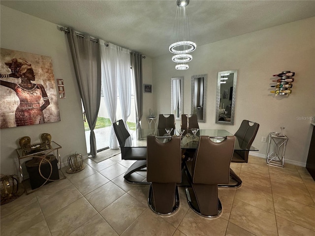 dining space with light tile patterned floors, a textured ceiling, and an inviting chandelier