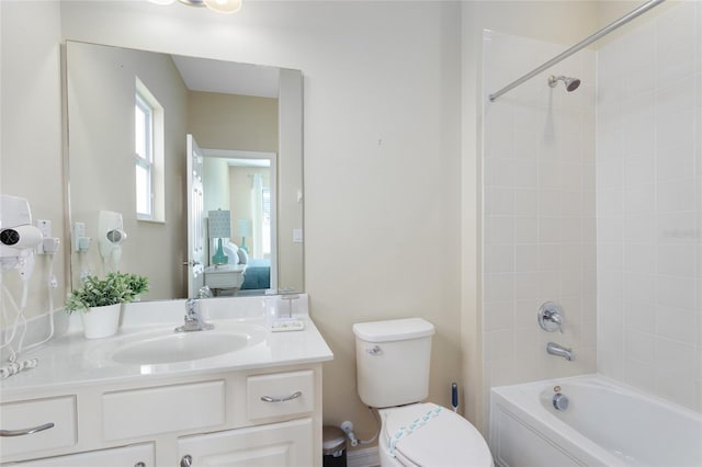 full bathroom with toilet, vanity, and tiled shower / bath