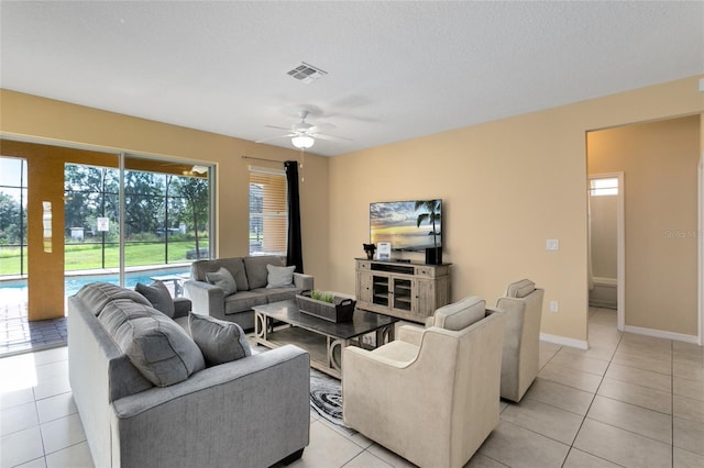 tiled living room featuring ceiling fan