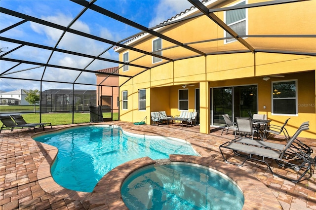 view of pool featuring glass enclosure, an outdoor living space, ceiling fan, an in ground hot tub, and a patio area