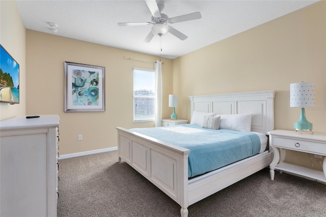 bedroom with ceiling fan and dark carpet