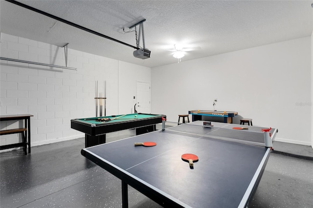 recreation room with a textured ceiling and pool table