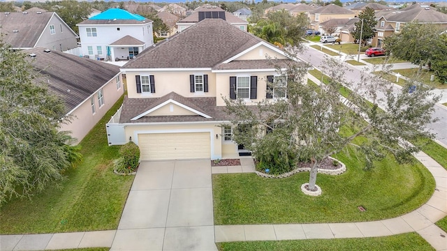 view of front of house featuring a front yard and a garage