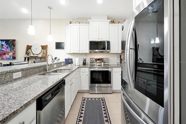 kitchen featuring sink, stainless steel appliances, white cabinetry, and light tile patterned floors