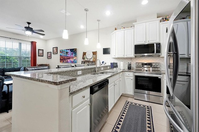 kitchen with sink, stainless steel appliances, white cabinets, and kitchen peninsula