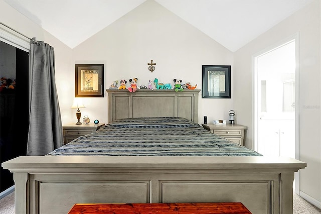 bedroom featuring light colored carpet and vaulted ceiling