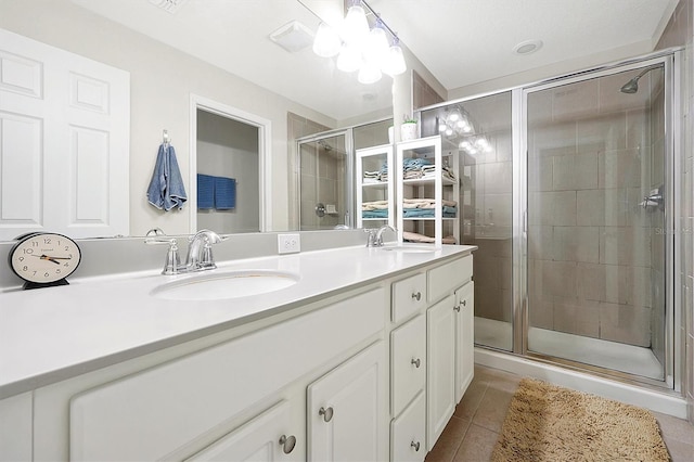 bathroom featuring a shower with shower door, tile patterned floors, and vanity