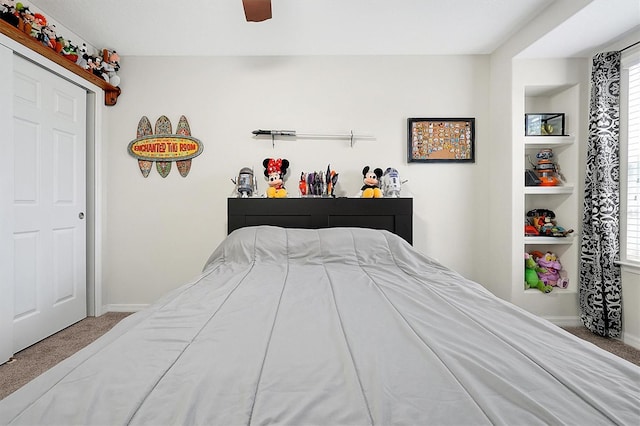 carpeted bedroom with ceiling fan and a closet