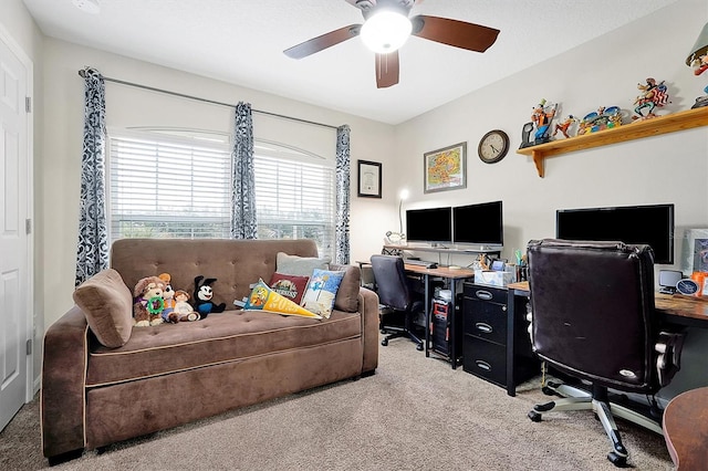 carpeted office featuring ceiling fan