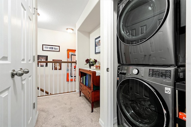 washroom with light colored carpet and stacked washer and clothes dryer