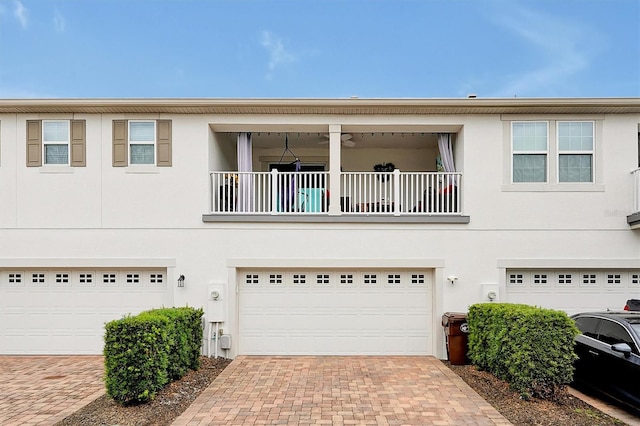 multi unit property featuring a balcony and a garage