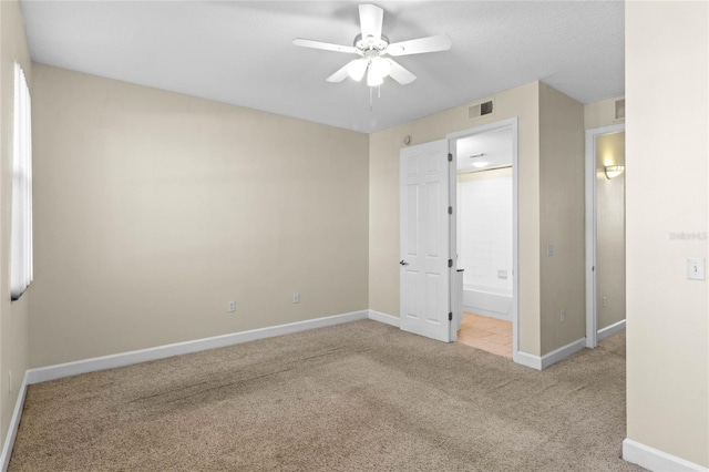 carpeted spare room with ceiling fan