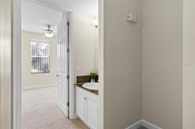 bathroom with ceiling fan and vanity