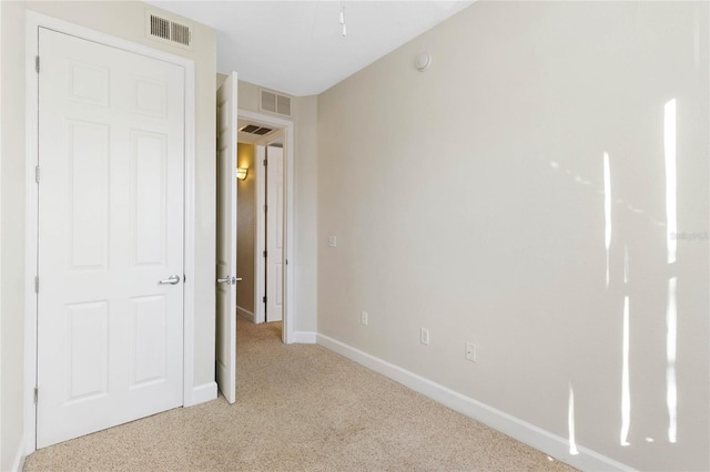 unfurnished bedroom featuring light colored carpet