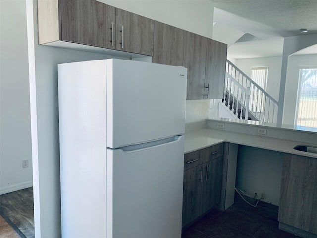 kitchen featuring white refrigerator and sink