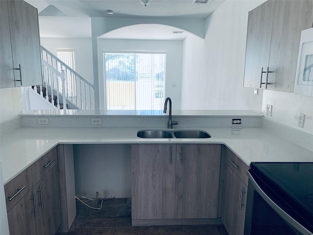 kitchen featuring range with electric cooktop and sink