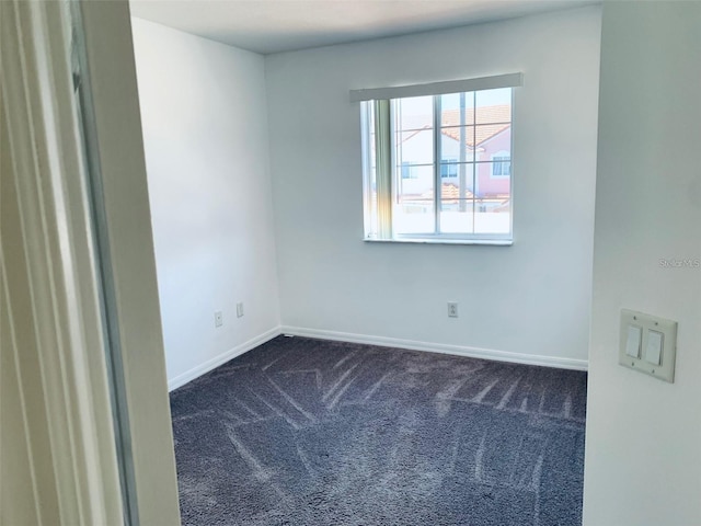 empty room with dark colored carpet