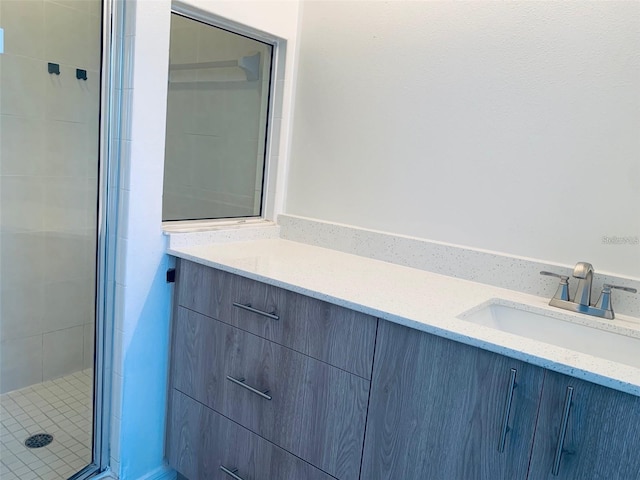 bathroom featuring vanity and a shower with door