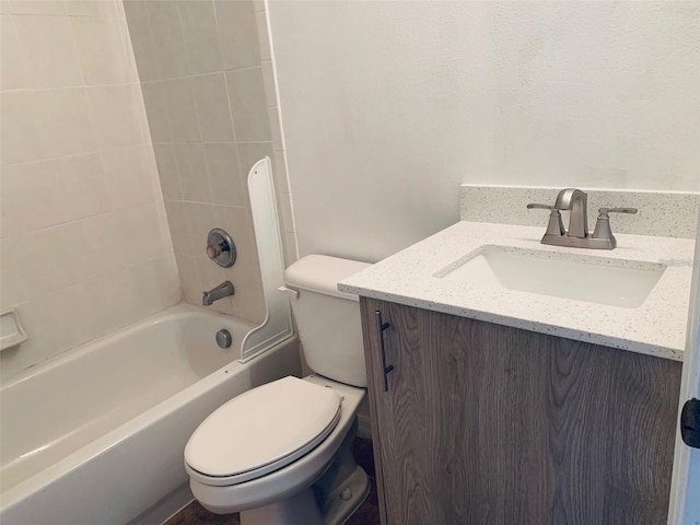 full bathroom with toilet, vanity, and tiled shower / bath