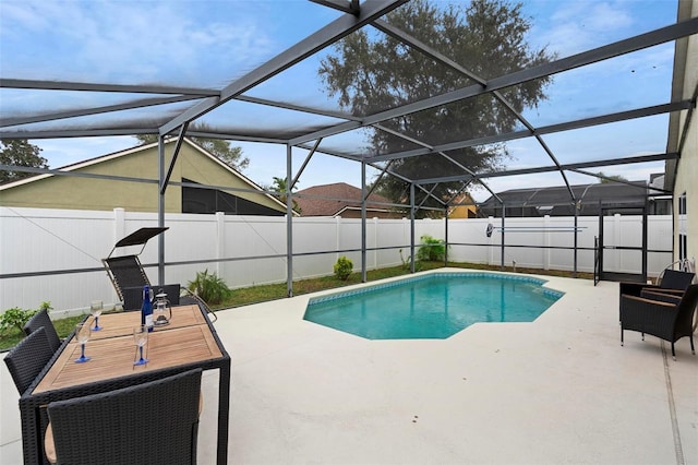 view of swimming pool with a patio area and a lanai