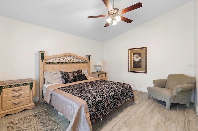 bedroom featuring ceiling fan, vaulted ceiling, and wood-type flooring