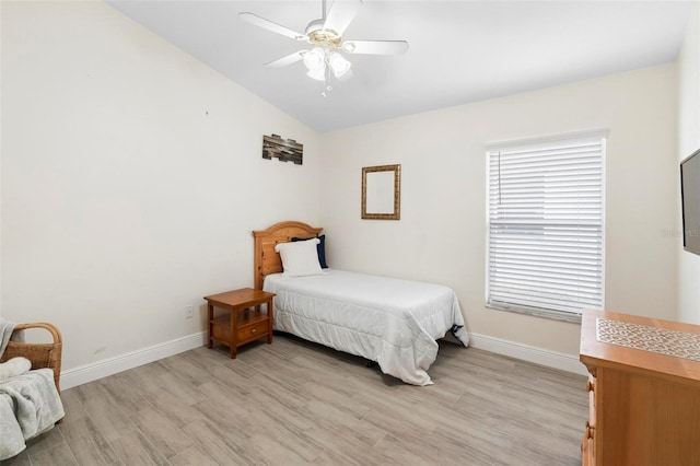 bedroom featuring light wood-type flooring, ceiling fan, and vaulted ceiling