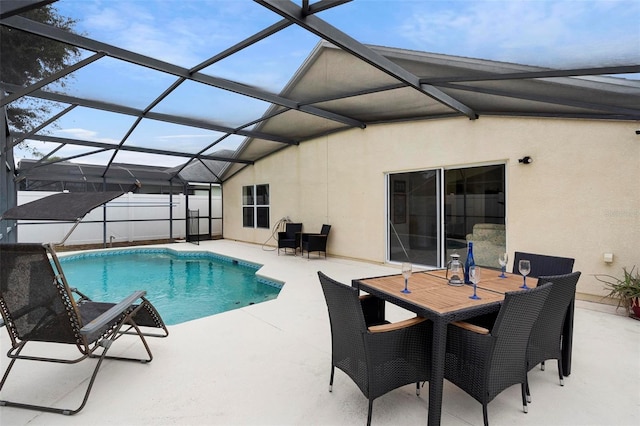 view of swimming pool featuring glass enclosure and a patio area