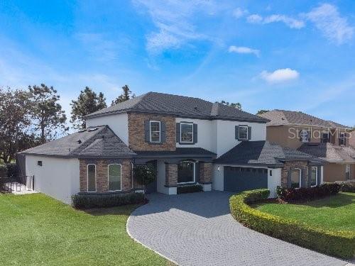 view of front property featuring a front lawn and a garage