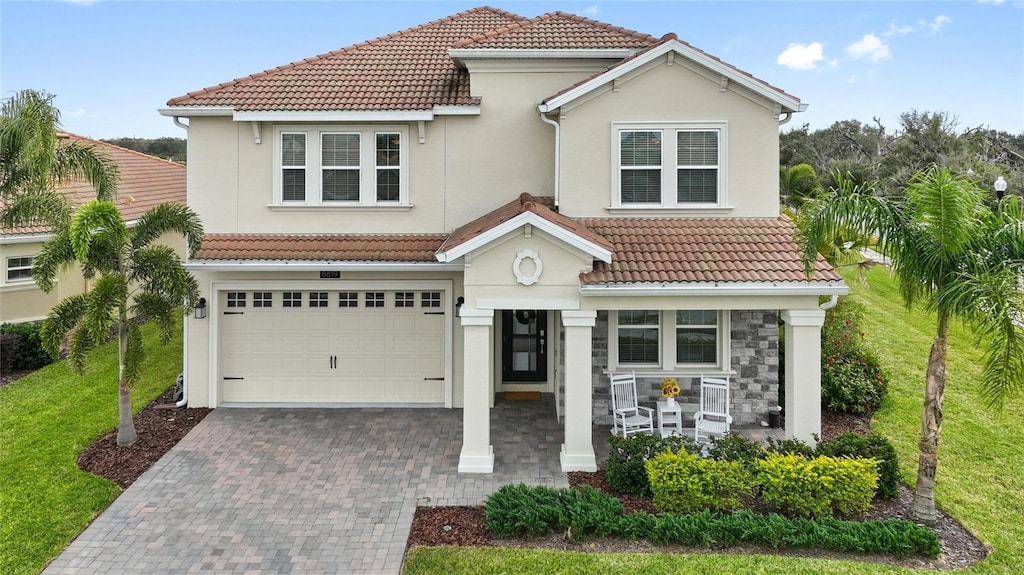 mediterranean / spanish-style home featuring a garage