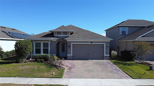 view of front facade featuring a garage and a front lawn