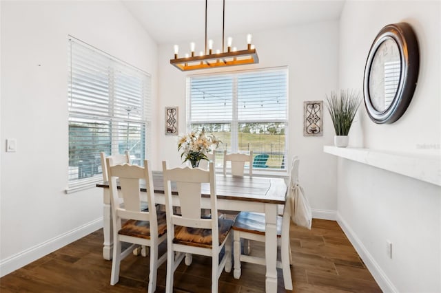 dining room featuring dark wood-type flooring and a notable chandelier