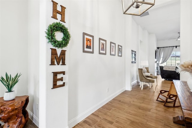 corridor with light hardwood / wood-style flooring