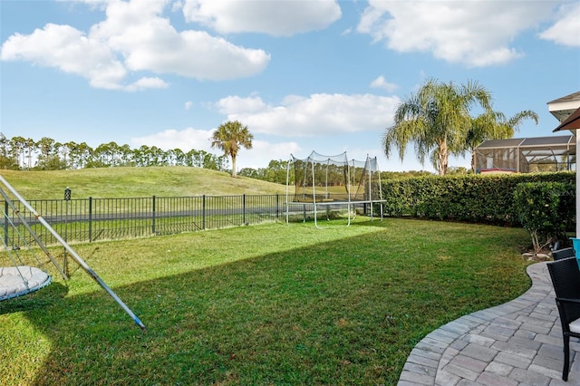 view of yard featuring a rural view and a trampoline