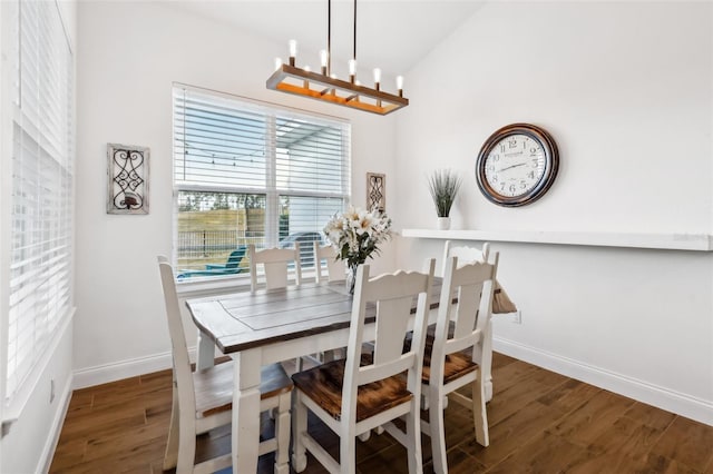 dining room featuring dark wood-type flooring and a chandelier