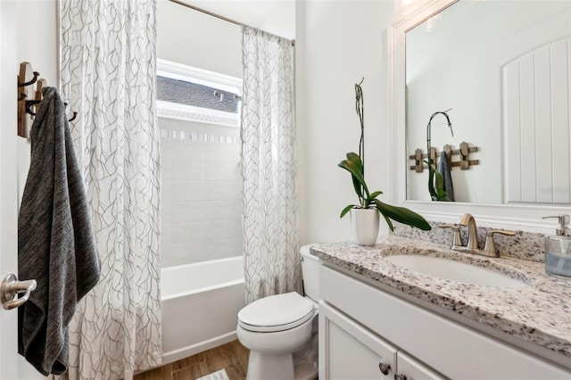 full bathroom with vanity, hardwood / wood-style flooring, shower / bath combo with shower curtain, and toilet