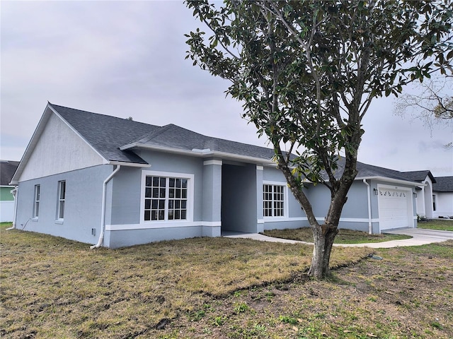 view of front of home with a front lawn and a garage