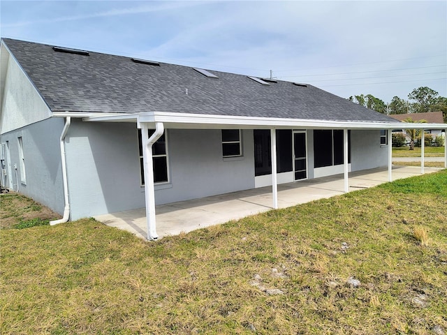 rear view of property featuring a patio area and a yard