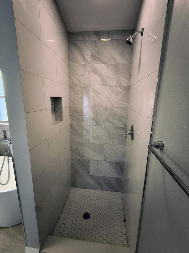 bathroom with a tile shower